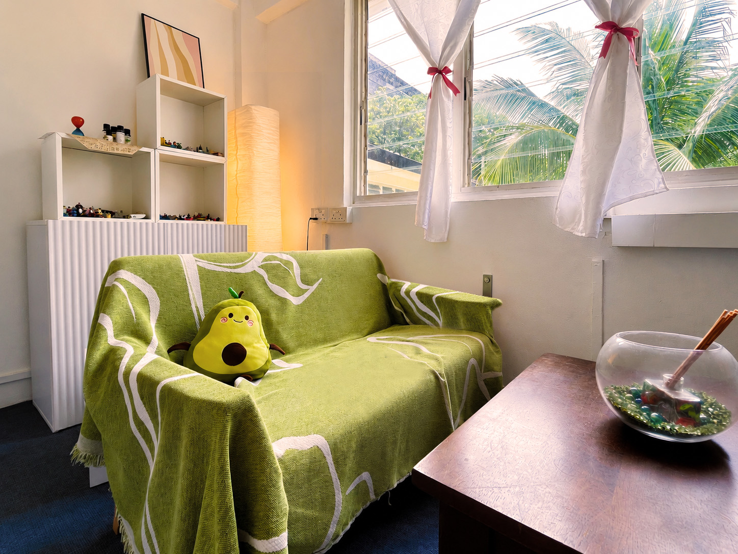Counselling room at Trybe’s Chinatown location with a green sofa and play therapy materials