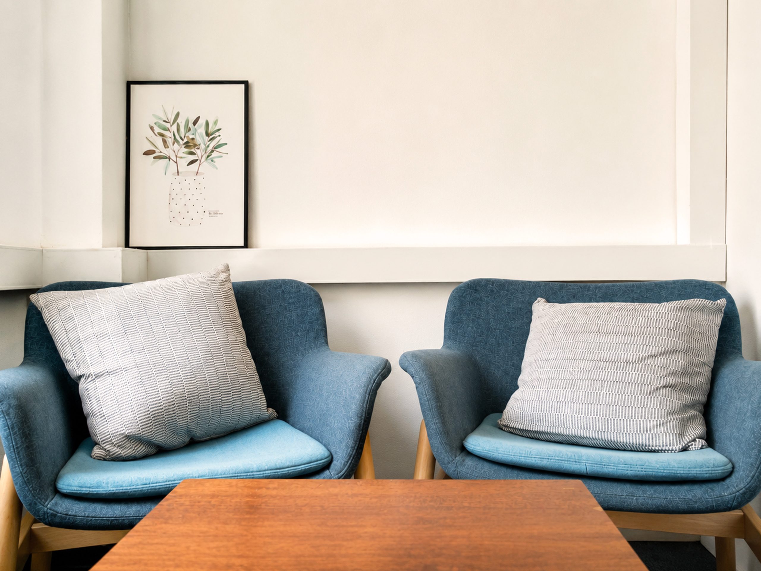 Two blue armchairs in a quiet counselling room